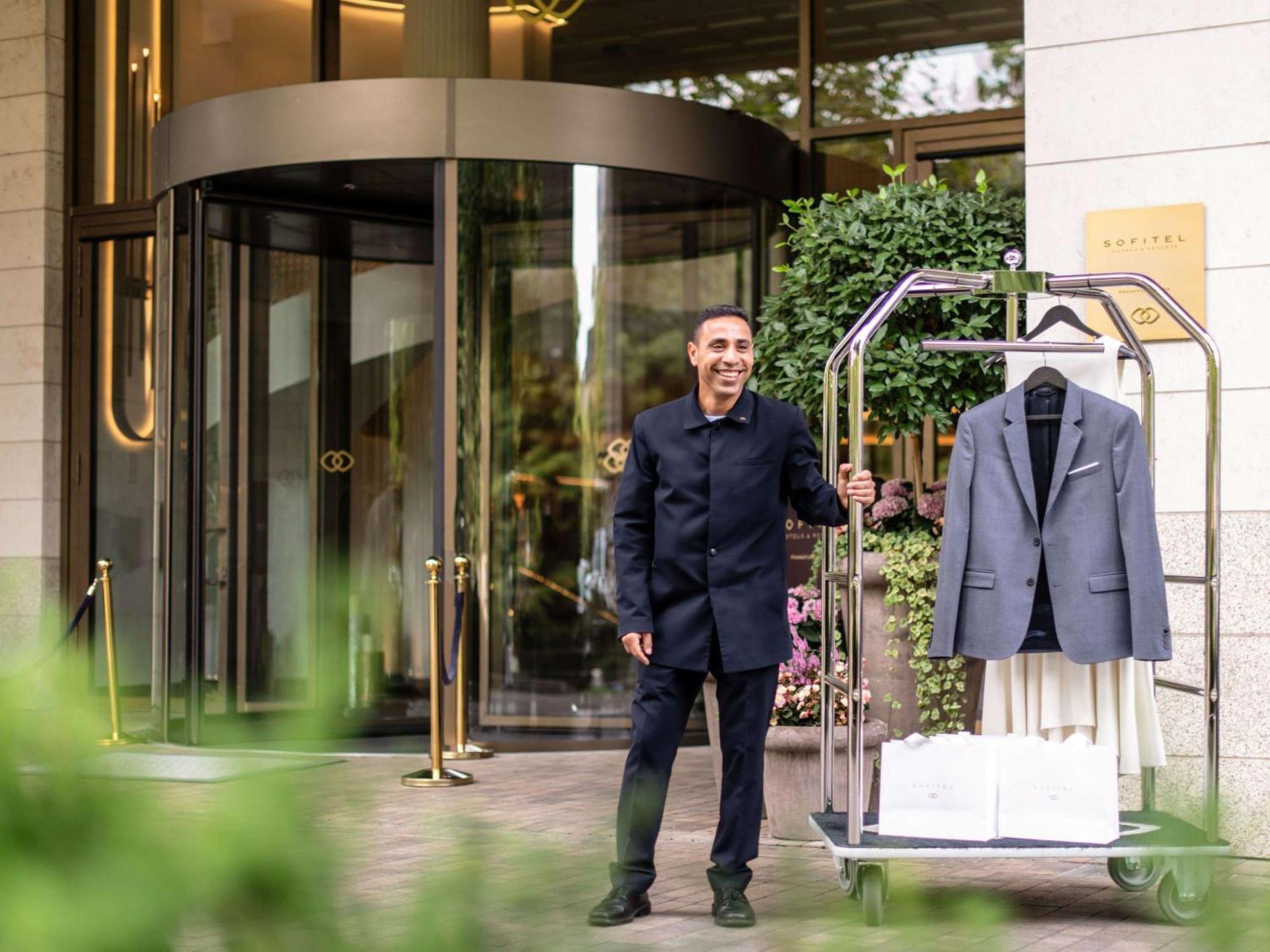 فندق سوفيتل فرانكفورت أوبرا المظهر الخارجي الصورة A bellboy at the entrance of a hotel
